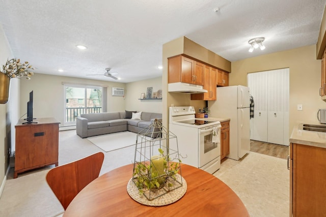 dining area with an AC wall unit, recessed lighting, a baseboard radiator, and a textured ceiling