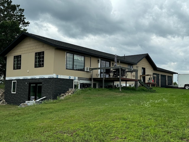 rear view of property featuring cooling unit, a deck, and a lawn