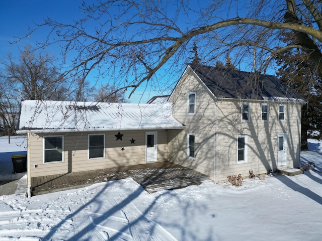 view of snow covered rear of property