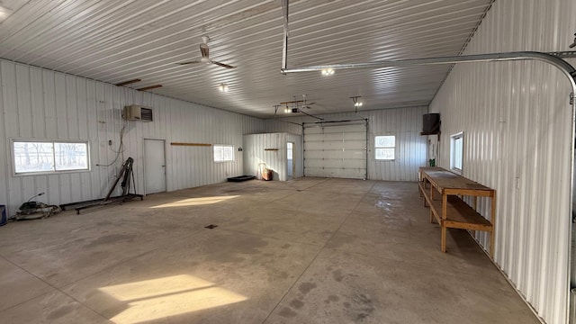 garage with a garage door opener and metal wall