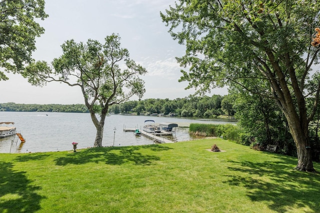 exterior space with a water view and a lawn