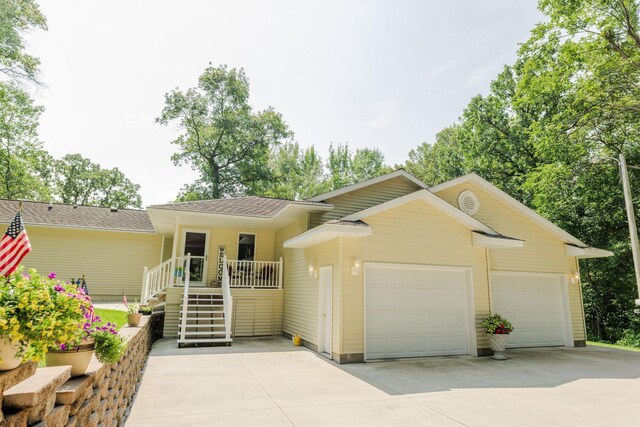 single story home with a garage, concrete driveway, and stairs