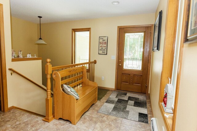 entrance foyer with a baseboard heating unit and baseboards