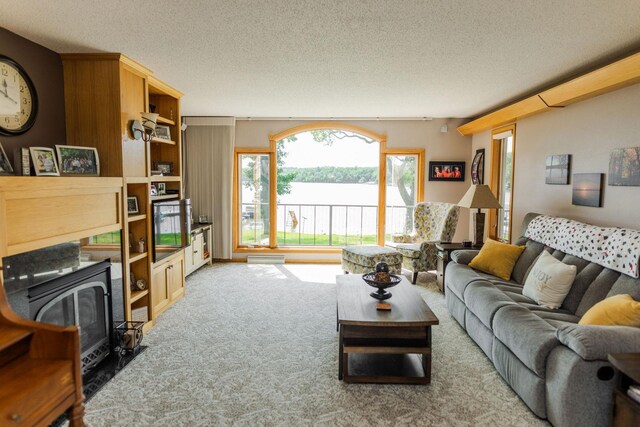 carpeted living area featuring a textured ceiling