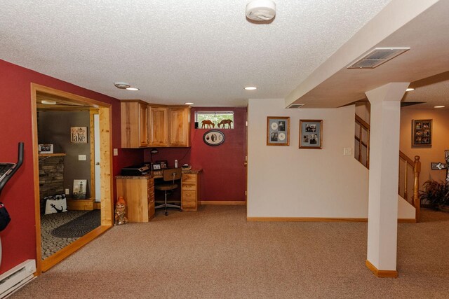 kitchen featuring dark countertops, a baseboard radiator, visible vents, and a textured ceiling