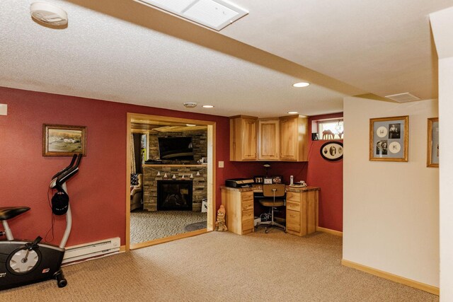 interior space with a fireplace, light colored carpet, visible vents, a baseboard heating unit, and baseboards