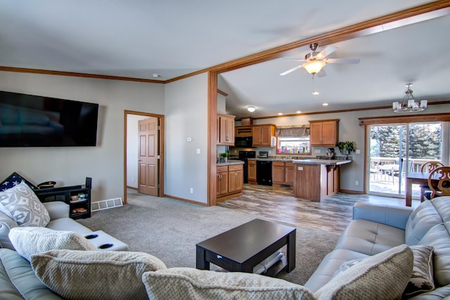 living room featuring visible vents, baseboards, lofted ceiling, ornamental molding, and a ceiling fan