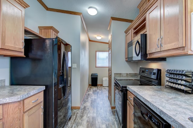 kitchen with crown molding, light brown cabinetry, light wood-type flooring, light countertops, and black appliances