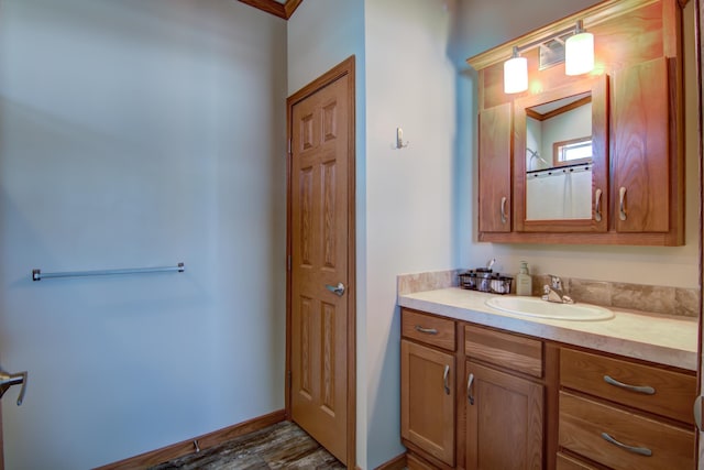 full bath featuring vanity and baseboards