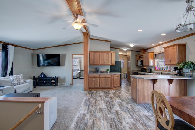 kitchen featuring visible vents, vaulted ceiling with beams, open floor plan, light countertops, and black appliances