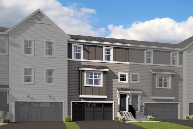 townhome / multi-family property featuring driveway, a garage, and board and batten siding