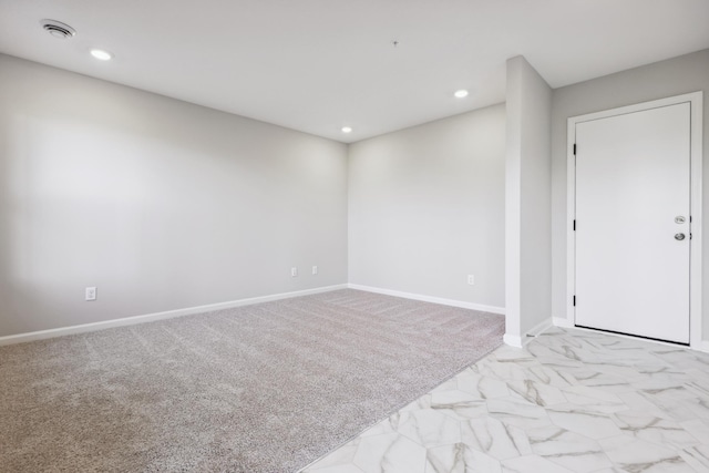 spare room featuring carpet, recessed lighting, and baseboards