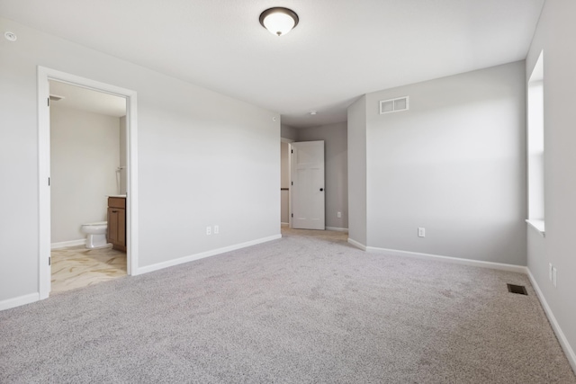 unfurnished bedroom featuring carpet, visible vents, and baseboards