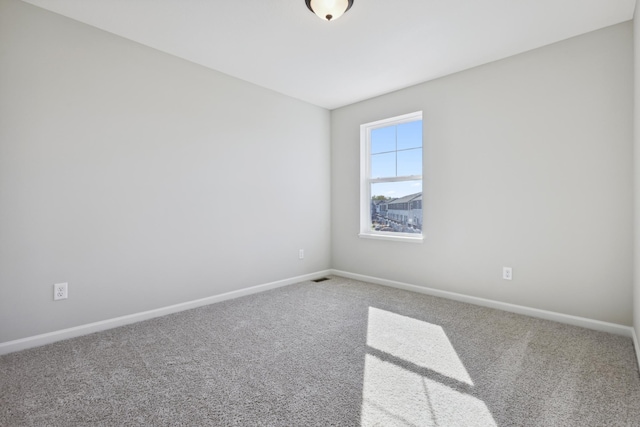 empty room with baseboards and carpet flooring