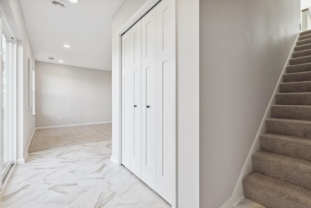 stairway featuring marble finish floor, baseboards, and recessed lighting