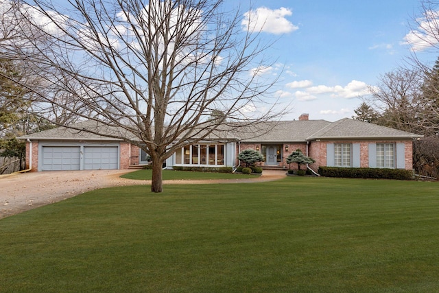 single story home with driveway, brick siding, a chimney, and a front yard