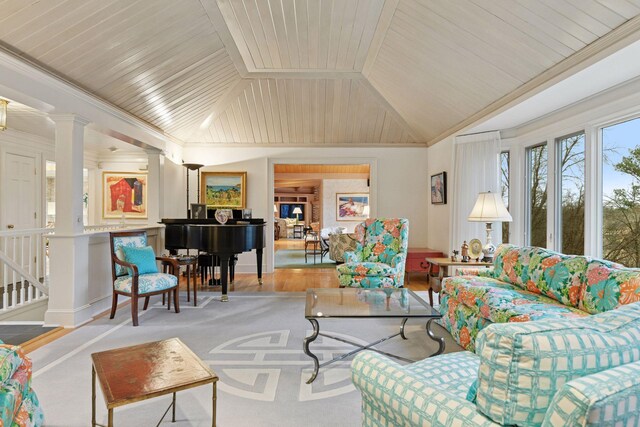 living room featuring vaulted ceiling, decorative columns, crown molding, and wooden ceiling