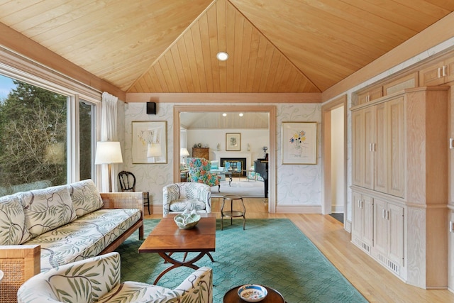 living room with wood ceiling, wallpapered walls, and vaulted ceiling