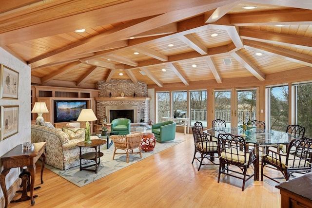 interior space featuring a healthy amount of sunlight, wooden ceiling, vaulted ceiling with beams, and wood finished floors