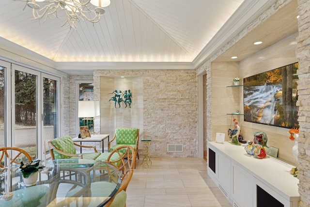 interior space featuring a chandelier, visible vents, and vaulted ceiling