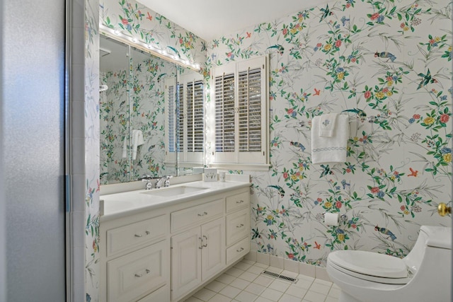 bathroom featuring visible vents, wallpapered walls, baseboards, toilet, and tile patterned floors