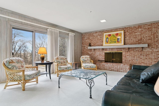 living area featuring a fireplace, brick wall, and carpet floors