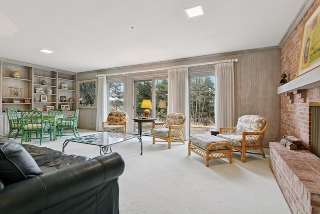 living area featuring light carpet, a brick fireplace, and wood walls