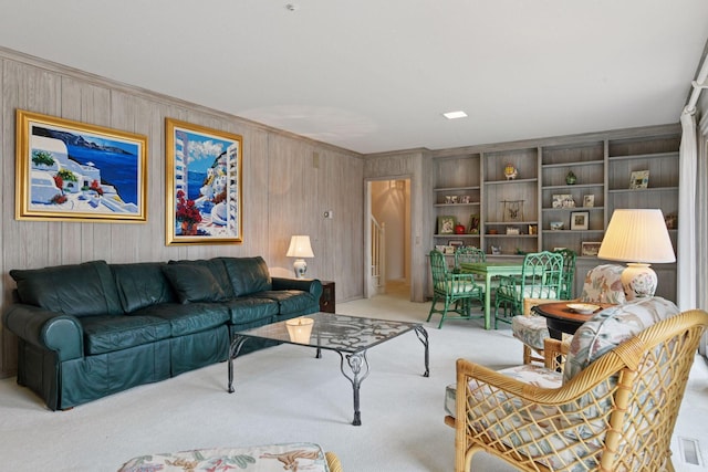 carpeted living area featuring ornamental molding