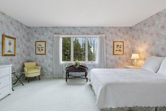 carpeted bedroom featuring wallpapered walls and baseboards