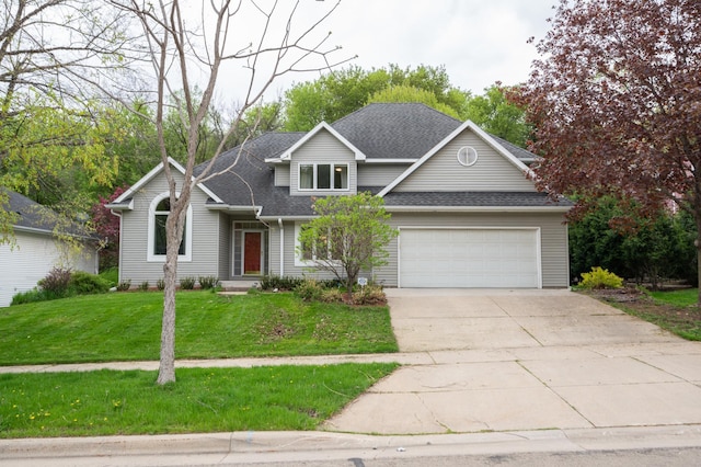 traditional home featuring a garage, a front lawn, driveway, and a shingled roof