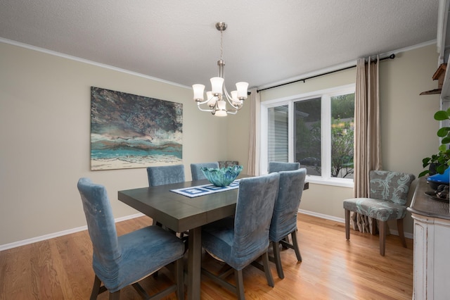 dining room featuring an inviting chandelier, light wood-style floors, baseboards, and a textured ceiling