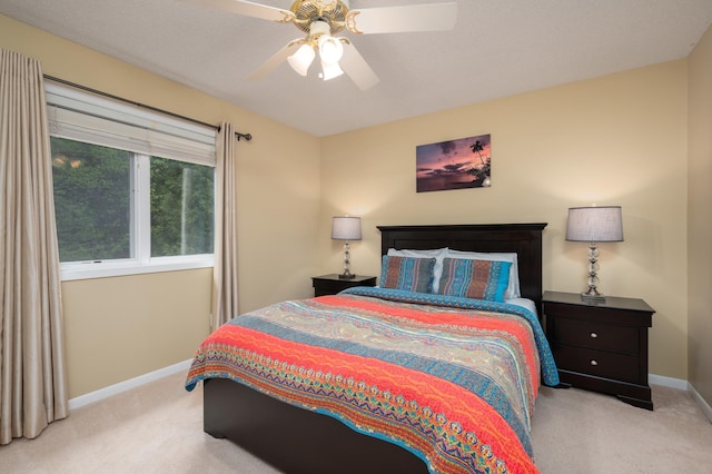 bedroom with baseboards, a ceiling fan, and carpet flooring