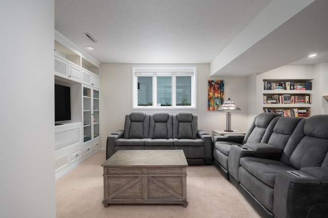 living area with light carpet, visible vents, recessed lighting, and a textured ceiling