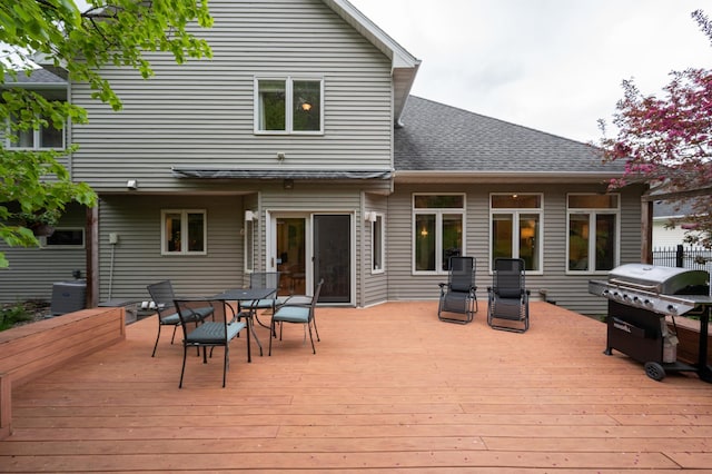 deck featuring grilling area and outdoor dining area