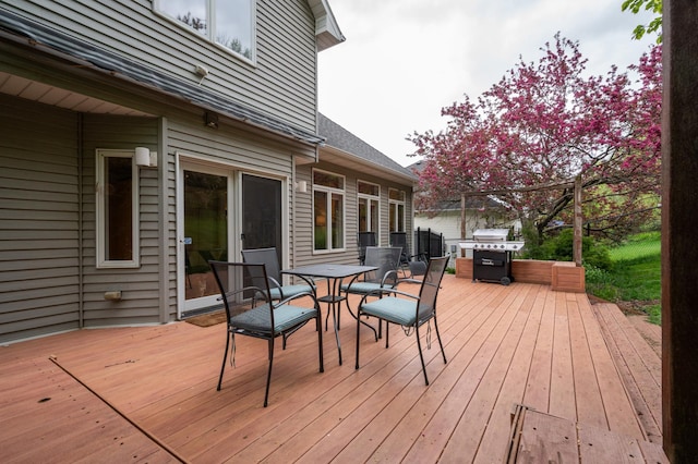 wooden deck featuring area for grilling