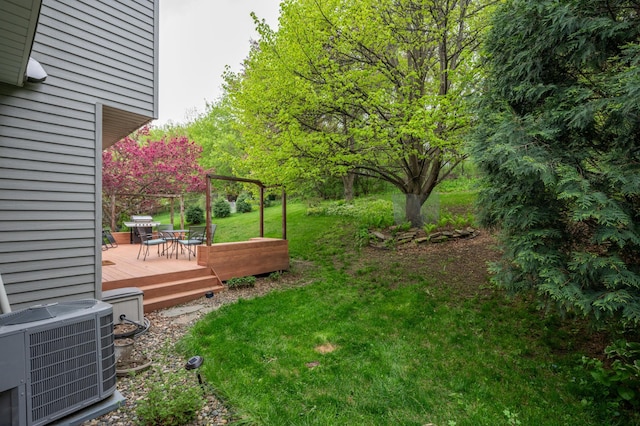 view of yard with cooling unit and a deck