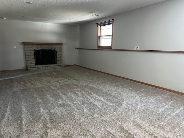 unfurnished living room featuring carpet, visible vents, baseboards, a fireplace, and a textured ceiling