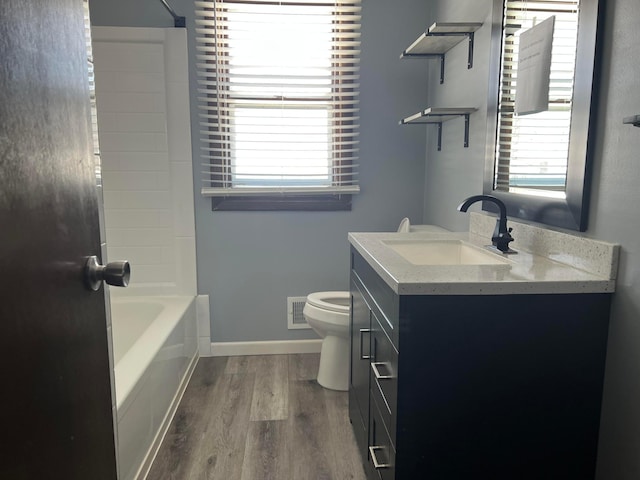 full bathroom featuring visible vents, plenty of natural light, toilet, and wood finished floors