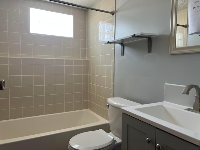 bathroom featuring a textured ceiling, toilet, vanity, and bathtub / shower combination