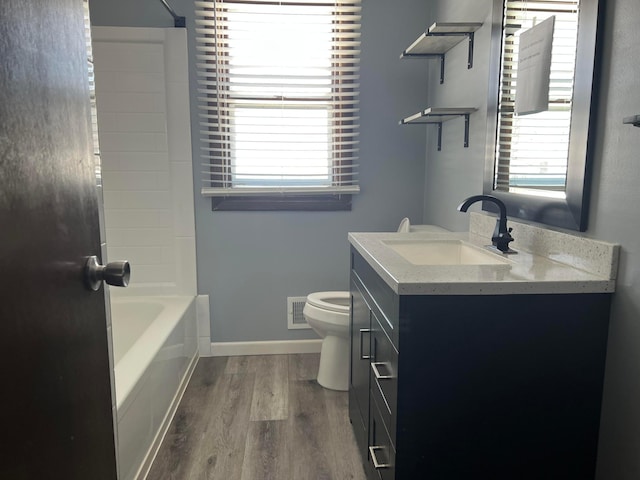 bathroom with visible vents, plenty of natural light, wood finished floors, and toilet