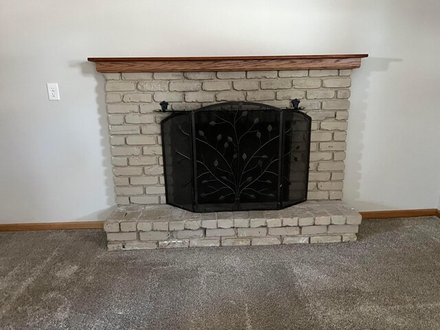 room details with carpet flooring, baseboards, and a fireplace