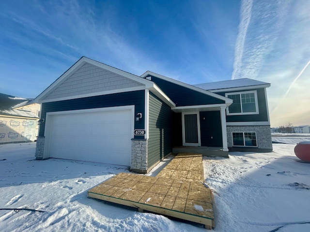 view of front of home featuring stone siding and an attached garage