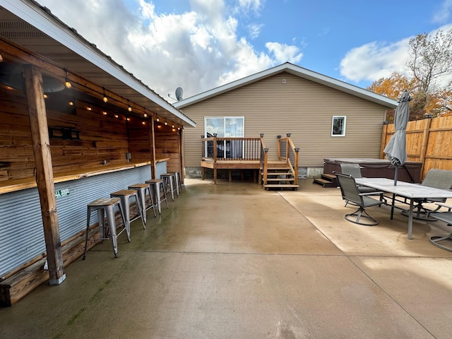 back of house with a patio area, fence, outdoor dry bar, and a wooden deck