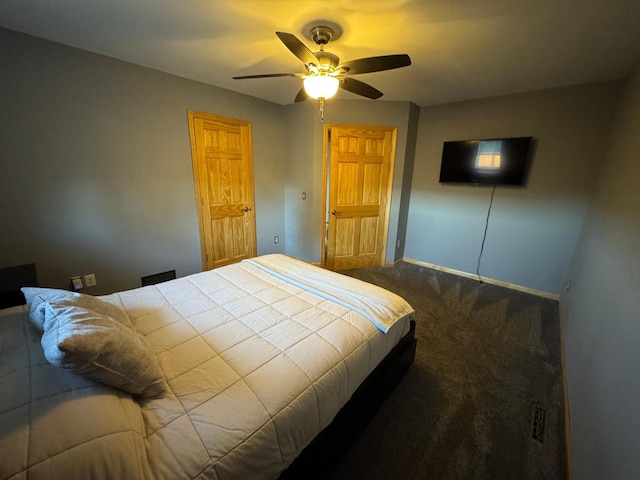 bedroom featuring dark carpet, a ceiling fan, and baseboards