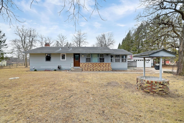 ranch-style home with a chimney and an outbuilding