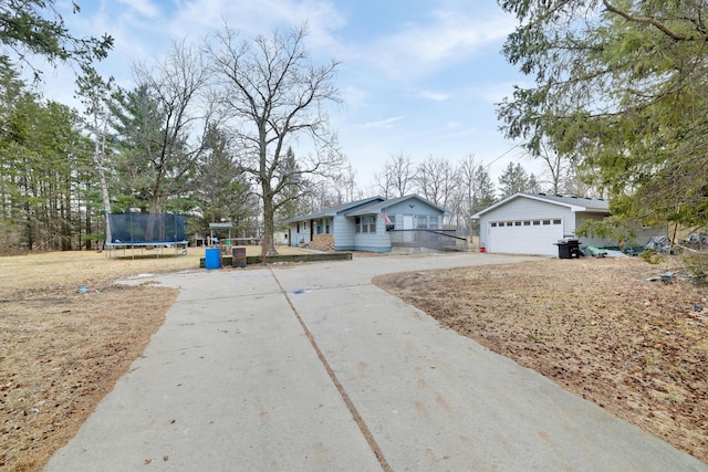 view of front facade with a garage and a trampoline