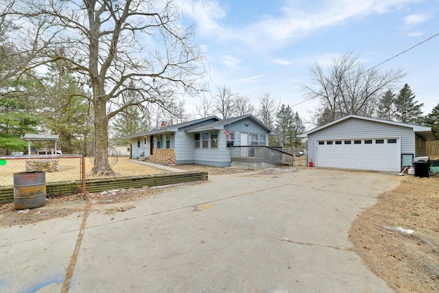 view of front facade with a garage, an outbuilding, fence, and a chimney