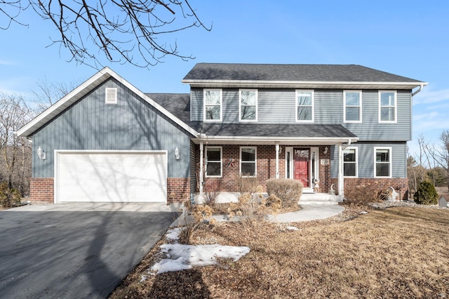 view of front of property with driveway, brick siding, roof with shingles, and an attached garage