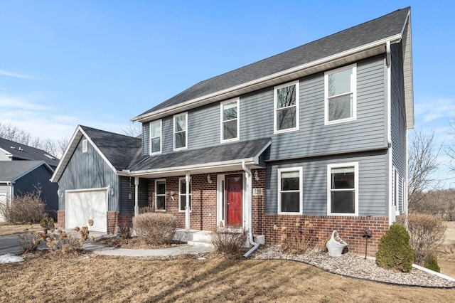 view of front facade with a garage and brick siding