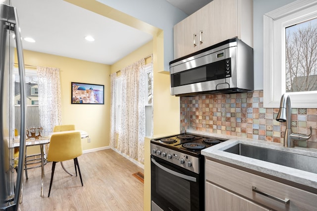 949 9th Ave SE, Rochester, MN 55904 - kitchen with a sink, a wealth of natural light, baseboards, and stainless steel appliances